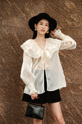 High-waisted silk skirt with pleated front and tailored silhouette for elegant styling